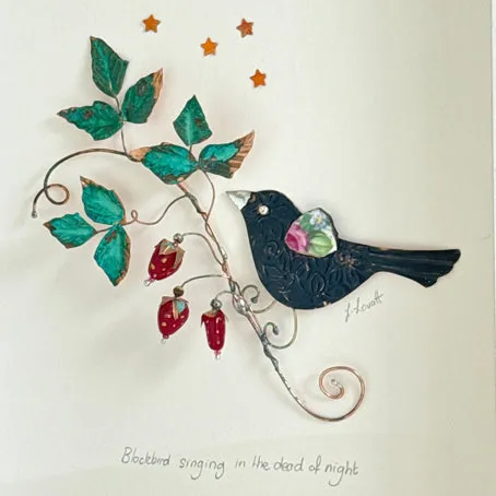 Blackbird singing with wild strawberries